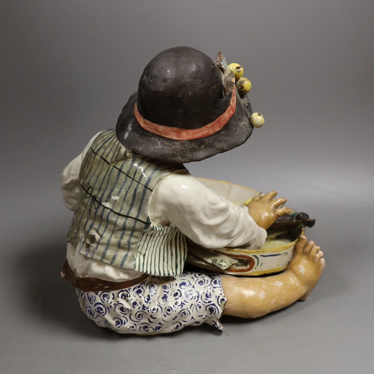 An early 20th century Italian maiolica figure of a boy with tambourine—29 cms high.